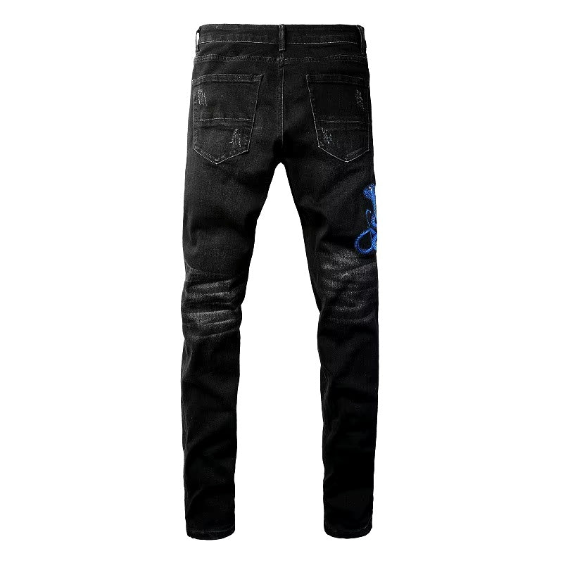 Jean noir délavé à broderie serpent