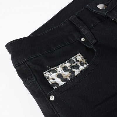 Schwarze Distressed Jeans mit Leoparden Patch Details