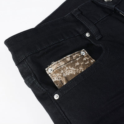 Schwarze Distressed Jeans mit goldenen Patch-Details