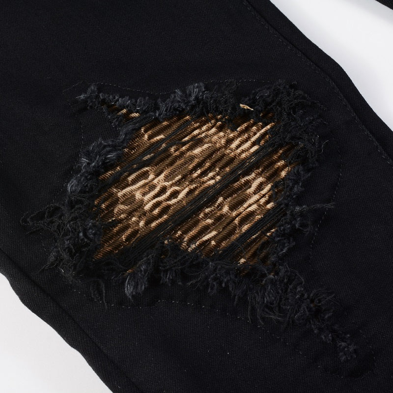 Schwarze Distressed Jeans mit goldenen Patch-Details