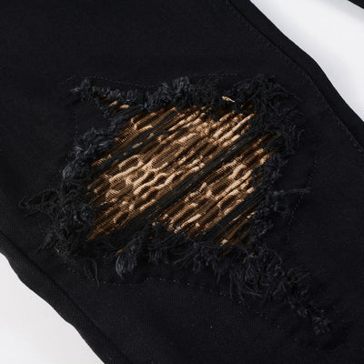 Schwarze Distressed Jeans mit goldenen Patch-Details